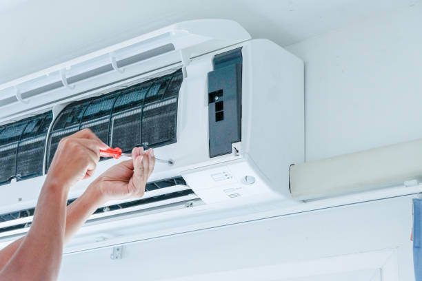 ac service the technician under repairing the air conditioner by use screwdriver