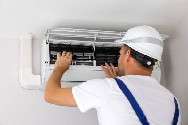 ac service air conditioner maintenance and repair. hvac service technician at work